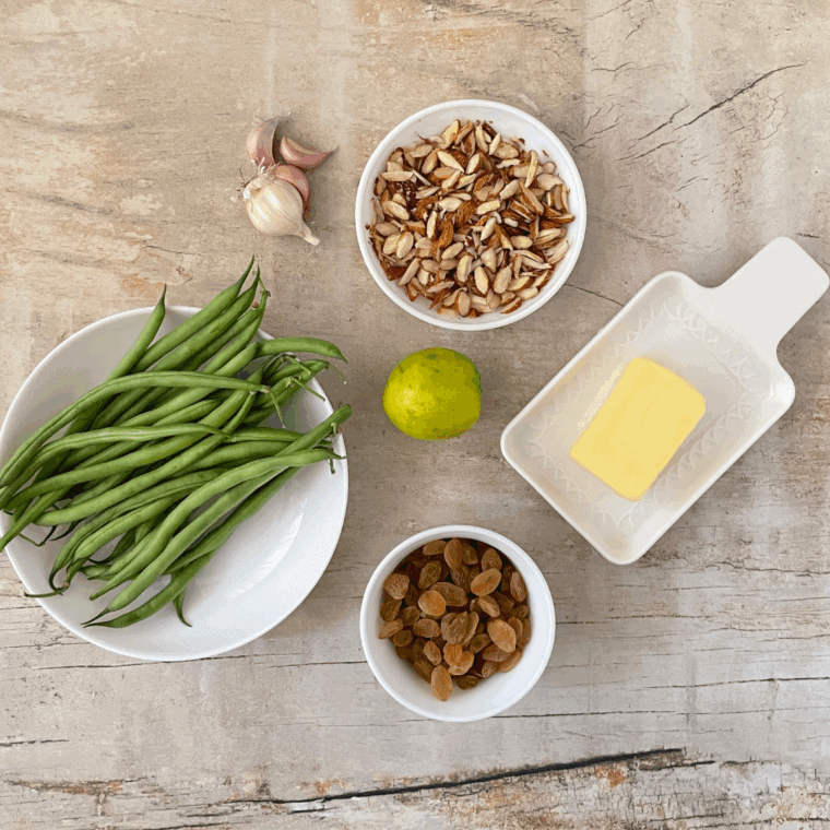 Ingredients needed for Air Fryer Green Beans Almondine on kitchen table.