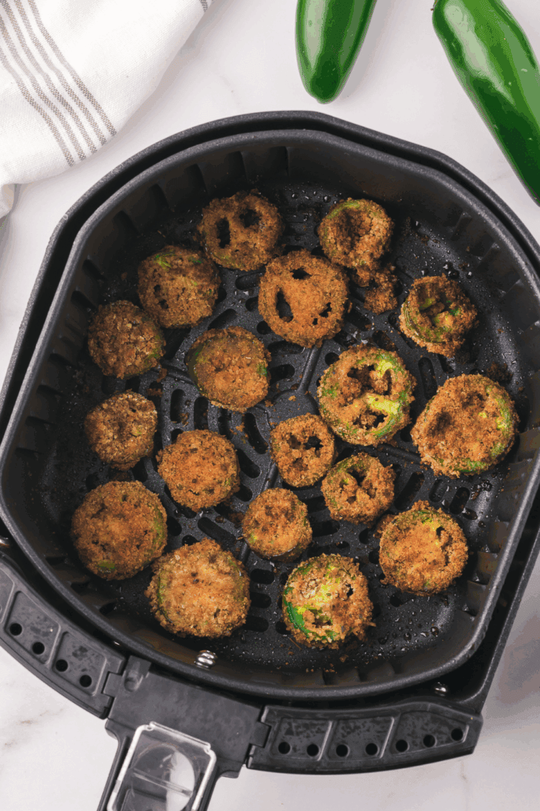 Crispy air taco coins are coated with breadcrumbs and parmesan cheese, offering a spicy kick and a golden texture inspired by Red Robin’s popular appetizer.