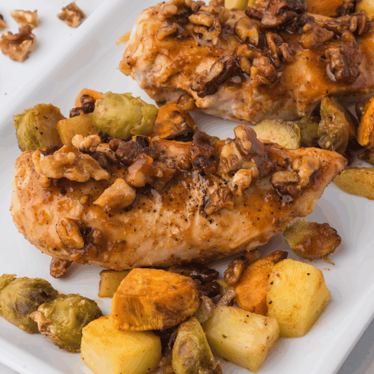 Crispy air-fried chicken topped with chopped walnuts and a maple glaze, served hot and golden on a plate.