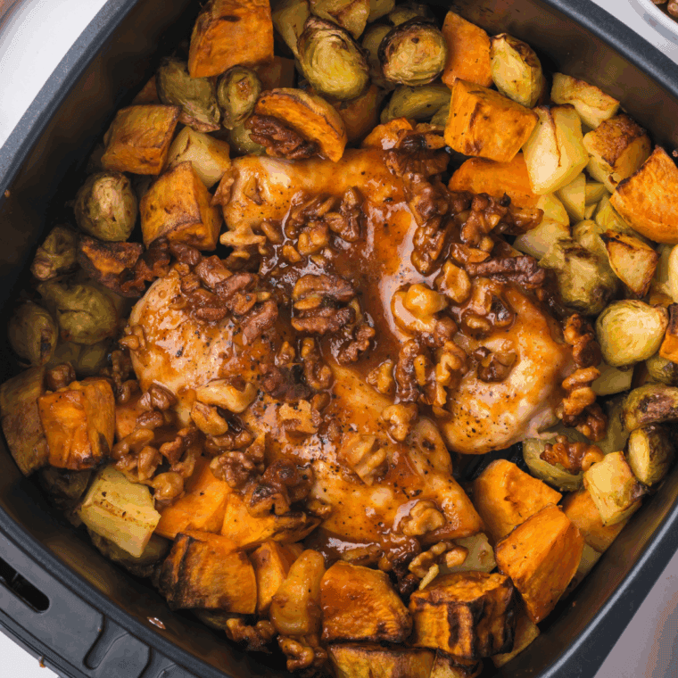 Golden air-fried chicken topped with maple walnut glaze, served with roasted sweet potatoes, Brussels sprouts, and apples.