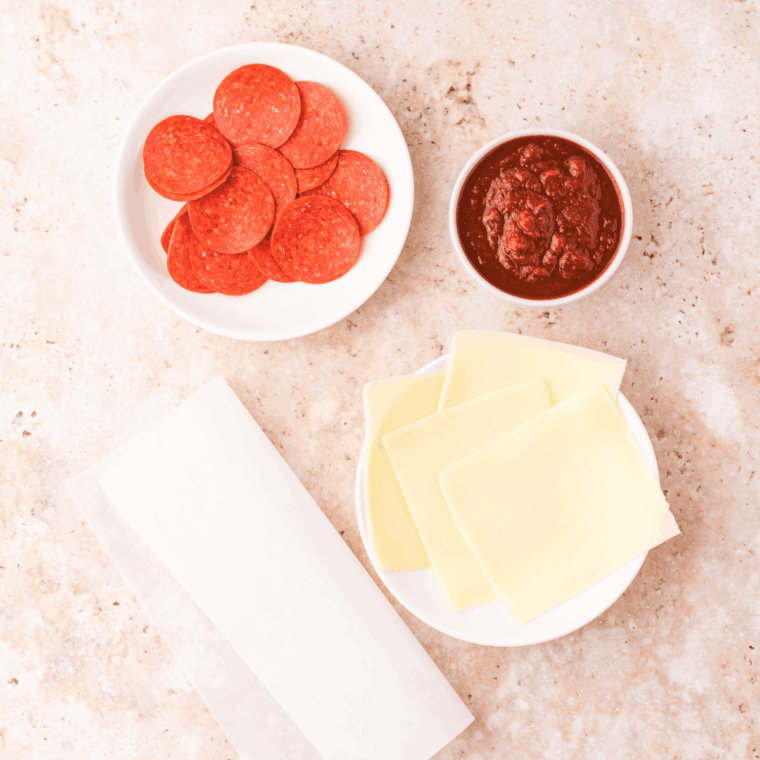 Ingredients needed for Air Fryer Pepperoni Cheese Crisps on kitchen table.