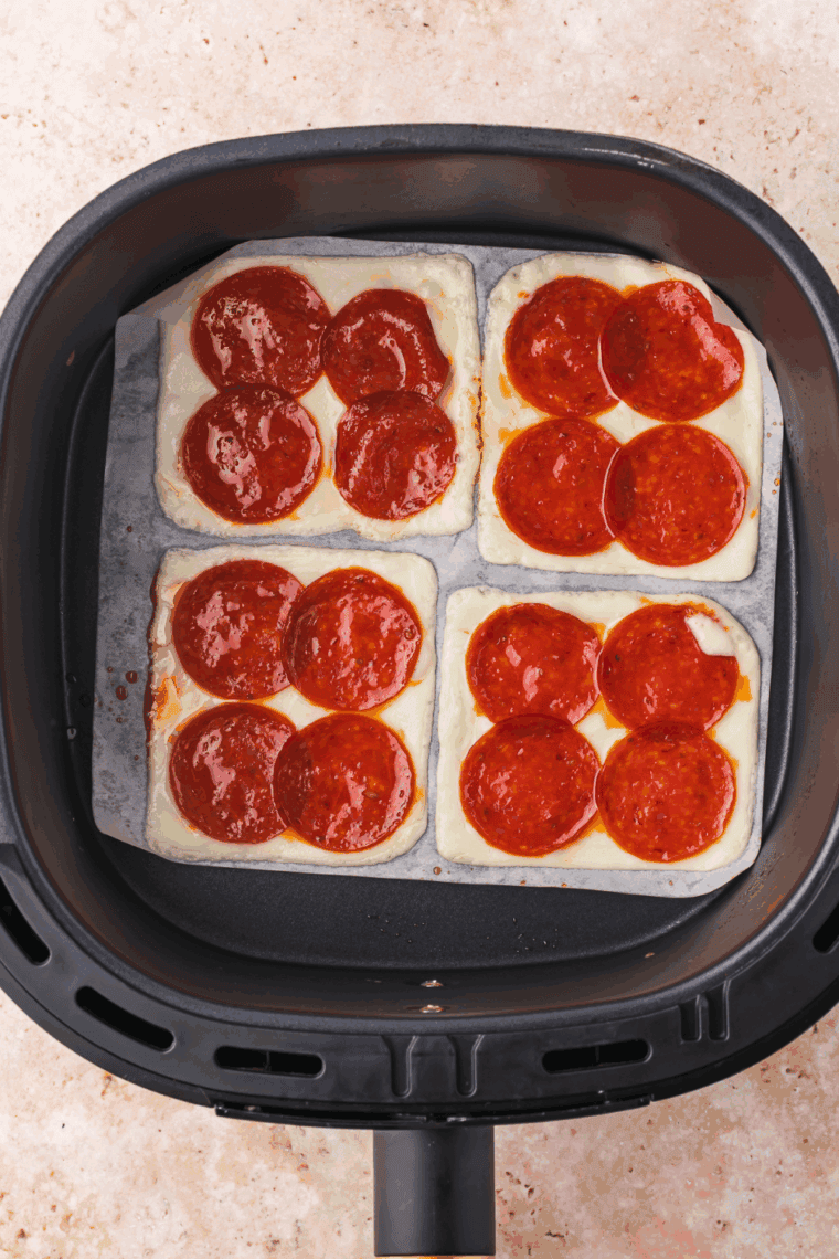 Crispy Air Fryer Pepperoni Cheese Crisps made with mozzarella cheese and pepperoni slices, perfect for dipping in pizza sauce.