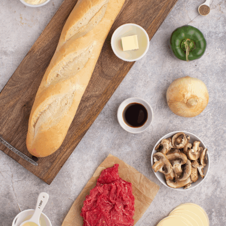 Ingredients needed for Air Fryer Philly Cheesesteak Cheesy Bread on kitchen table.