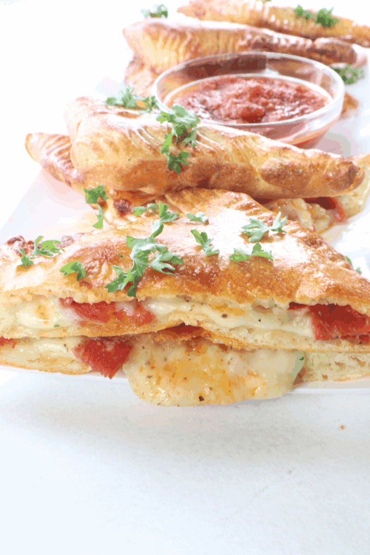 Plate of Air Fryer Pizza Turnovers, with dipping sauce.