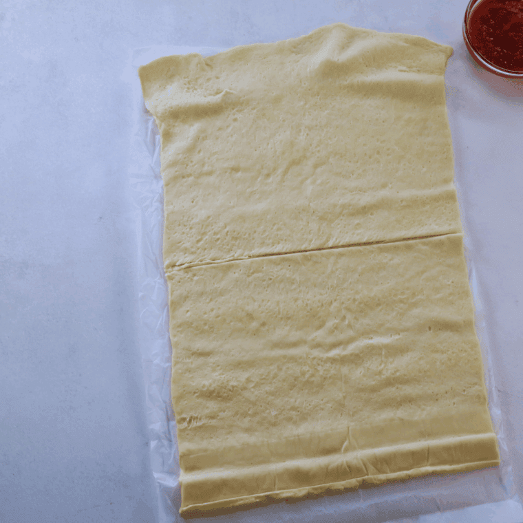 Unroll the crescent rolls dough on flat surface.