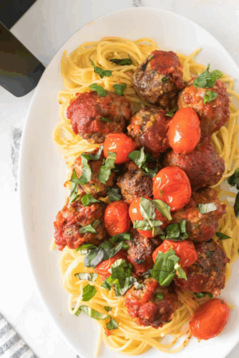 Golden, crispy Air Fryer Spaghetti and Meatballs, served with marinara sauce, ready to enjoy for a tasty and easy dinner.