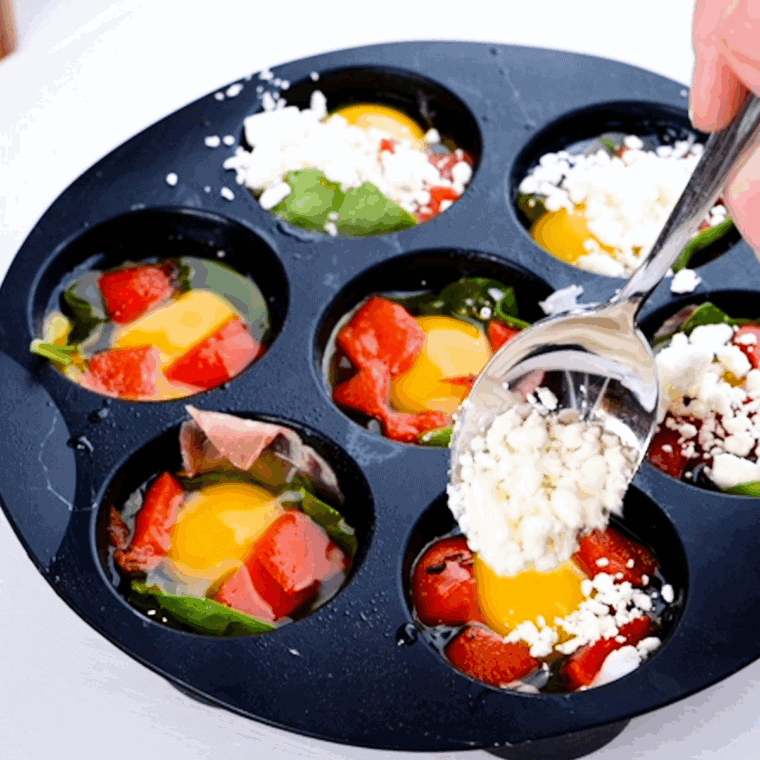 Muffin tin filled with egg mixture placed inside air fryer basket set to 330°F for cooking.