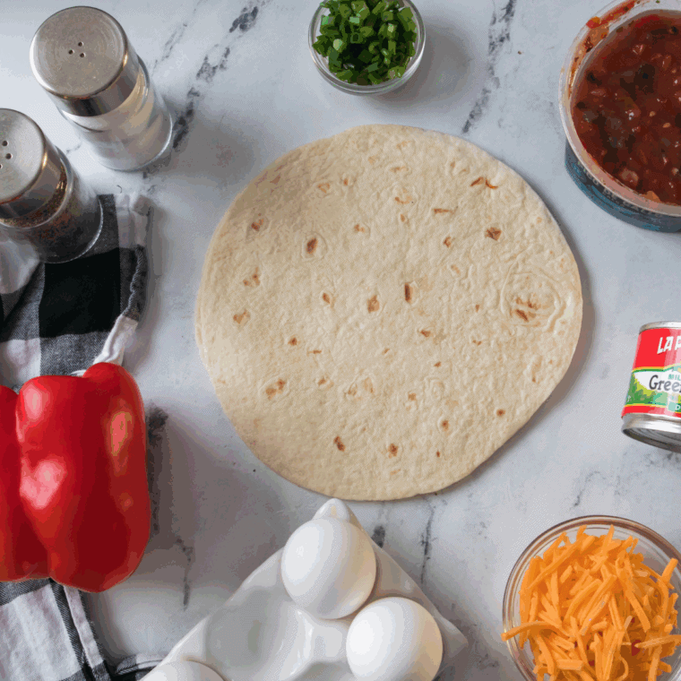 Ingredients needed for Air Fryer Tortilla Baked Eggs on kitchen table.