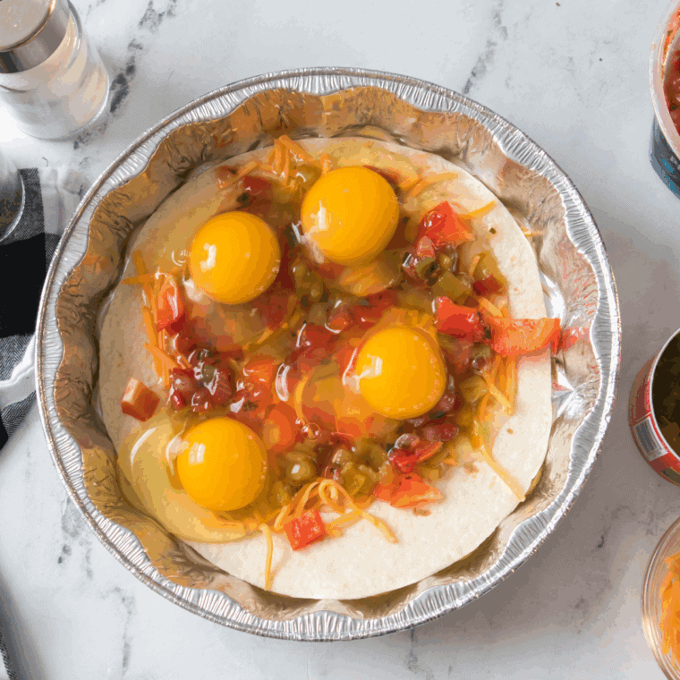 Add all of the ingredients onto the tortilla shell.
