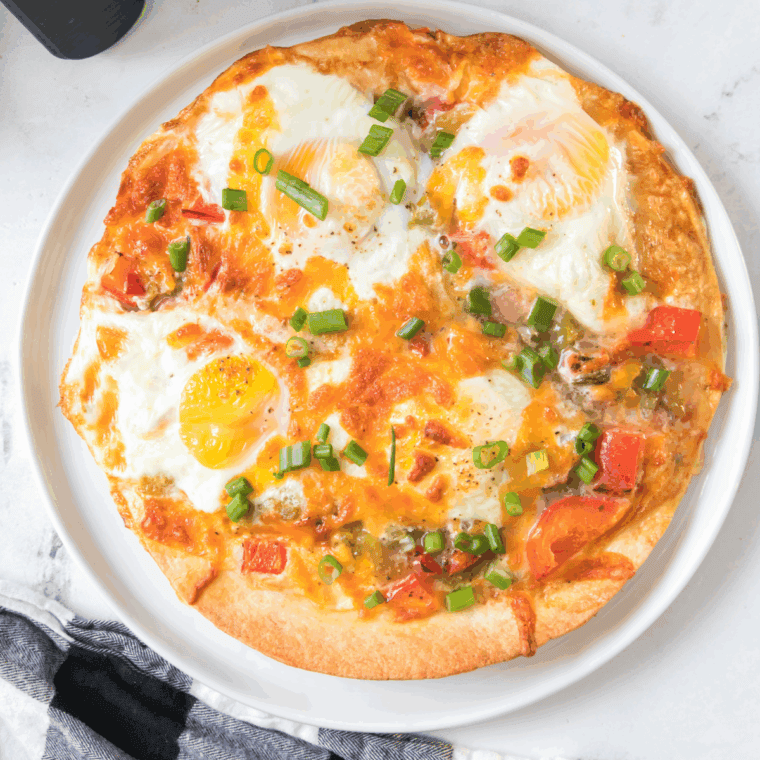 Air Fryer Tortilla Baked Eggs with a crispy tortilla base, topped with cheese and eggs, ready to serve for breakfast or brunch.