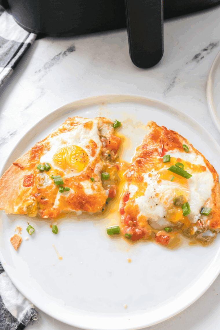 Air Fryer Tortilla Baked Eggs with a crispy tortilla base, melted cheese, and perfectly baked eggs, ready to serve for breakfast or brunch.