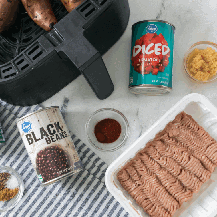 Ingredients needed for Air Fryer Turkey Chili Smothered Sweet Potatoes on kitchen table.