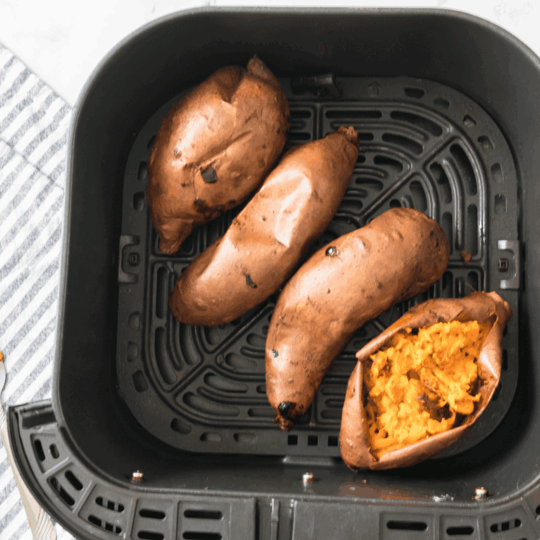 Cooked sweet potatoes in the air fryer basket.