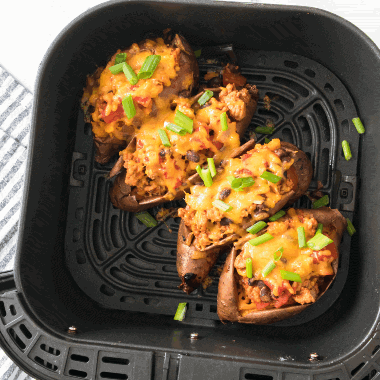 Air Fryer Turkey Chili Smothered Sweet Potatoes, roasted sweet potatoes topped with savory turkey chili, ready to serve for a hearty and nutritious meal.