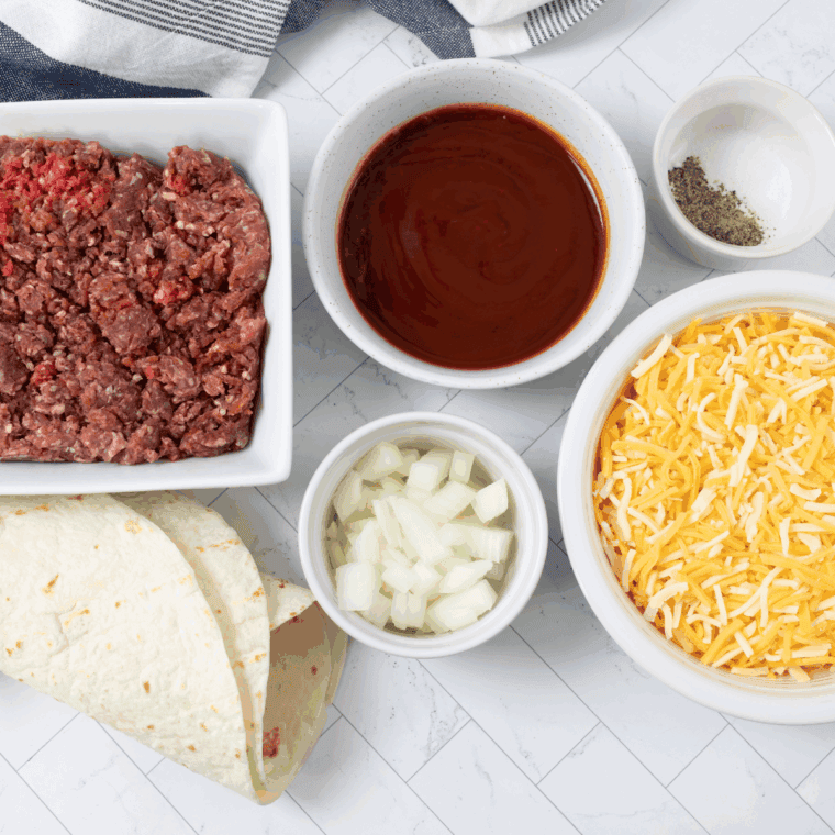 Ingredients needed for Blackstone Wet Burrito on kitchen table.