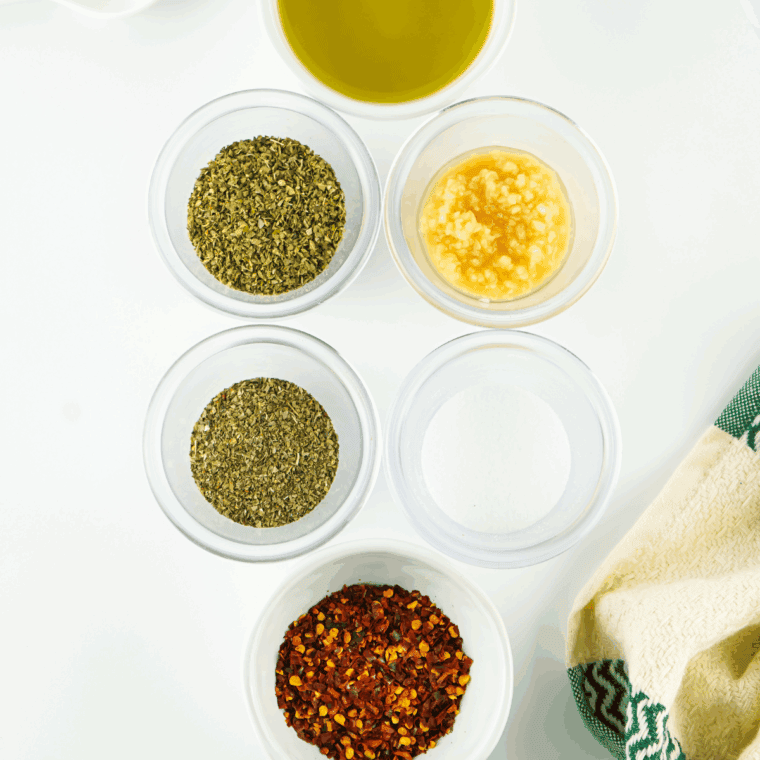 Ingredients needed for Bravo Dipping Oil Recipe on kitchen table.