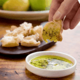 Bravo-style dipping oil made with olive oil, garlic, herbs, and spices, perfect for dipping fresh bread."
