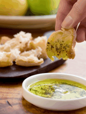 Bravo-style dipping oil made with olive oil, garlic, herbs, and spices, perfect for dipping fresh bread."