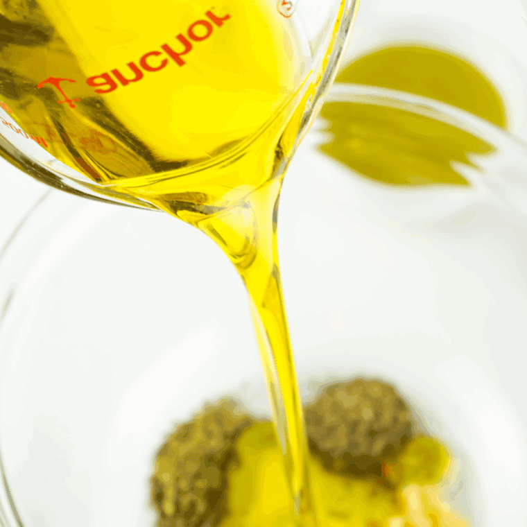 Slowly pour the olive oil into the mixing bowl.