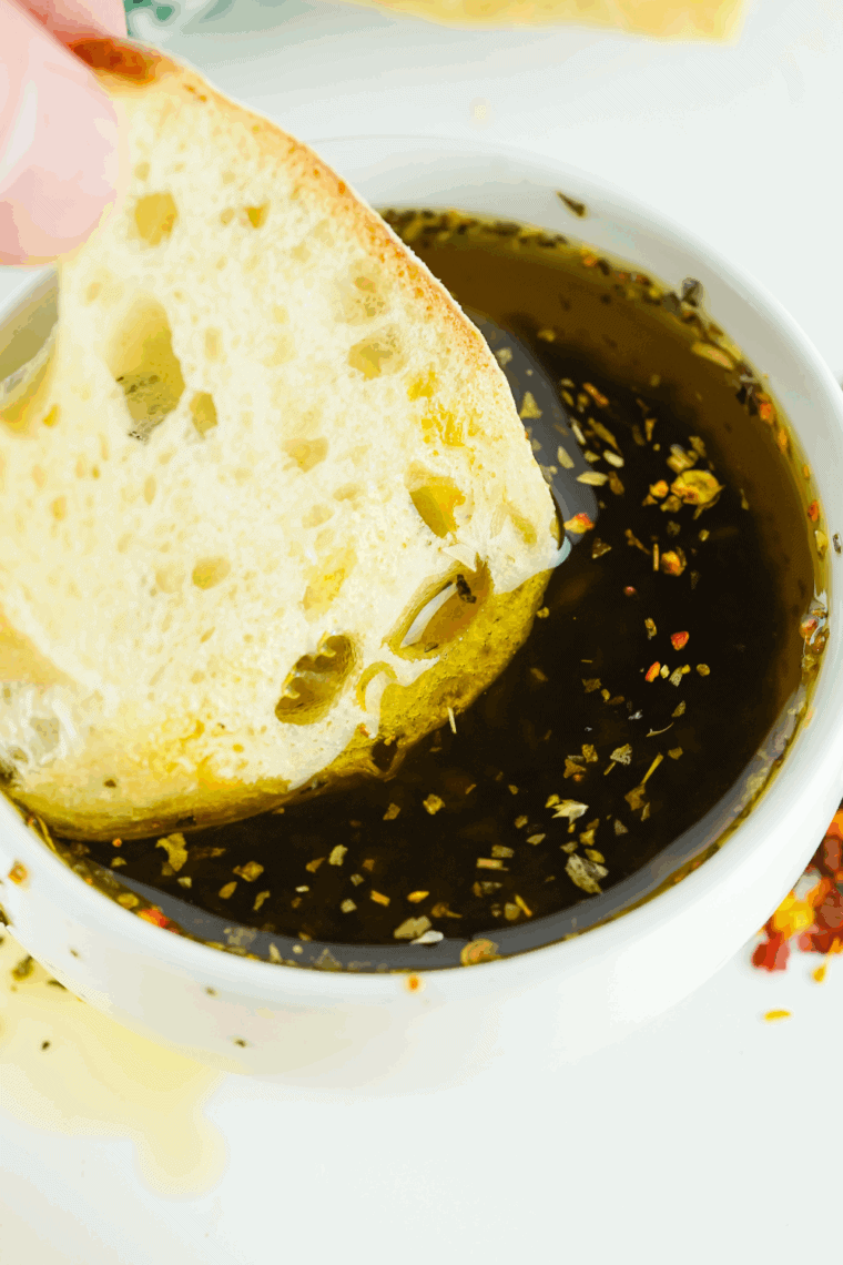 Bravo-style dipping oil made with olive oil, garlic, sun-dried tomato paste, and herbs, perfect for dipping crusty bread.