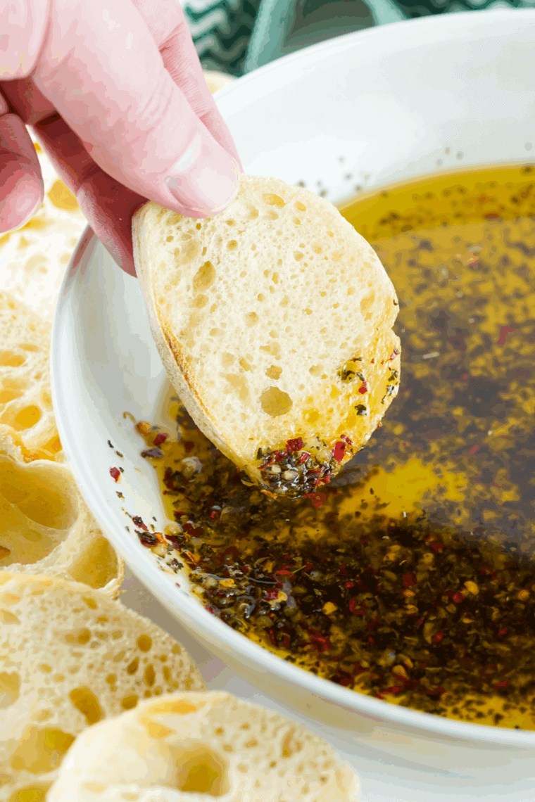 Bravo-style dipping oil made with olive oil, garlic, sun-dried tomato paste, and herbs, ideal for dipping crusty bread.