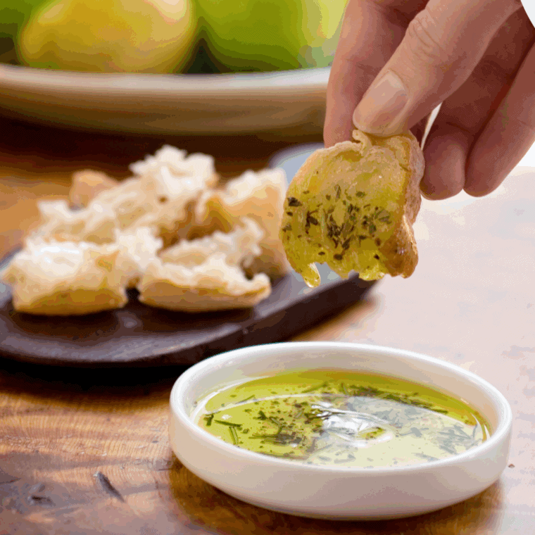 Bravo-style dipping oil made with olive oil, garlic, herbs, and spices, perfect for dipping fresh bread.