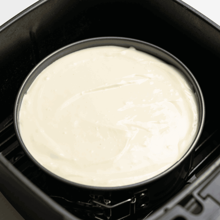 Set unbaked cheesecake into the air fryer basket.