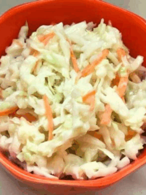 Bowl of creamy Cracker Barrel copycat coleslaw with shredded cabbage and carrots.
