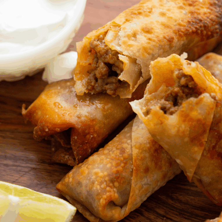 Crispy golden egg rolls filled with seasoned pork and shredded vegetables, served with dipping sauce.