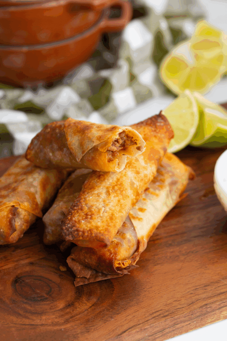 Golden crispy egg rolls filled with seasoned pork and shredded vegetables served with dipping sauce.