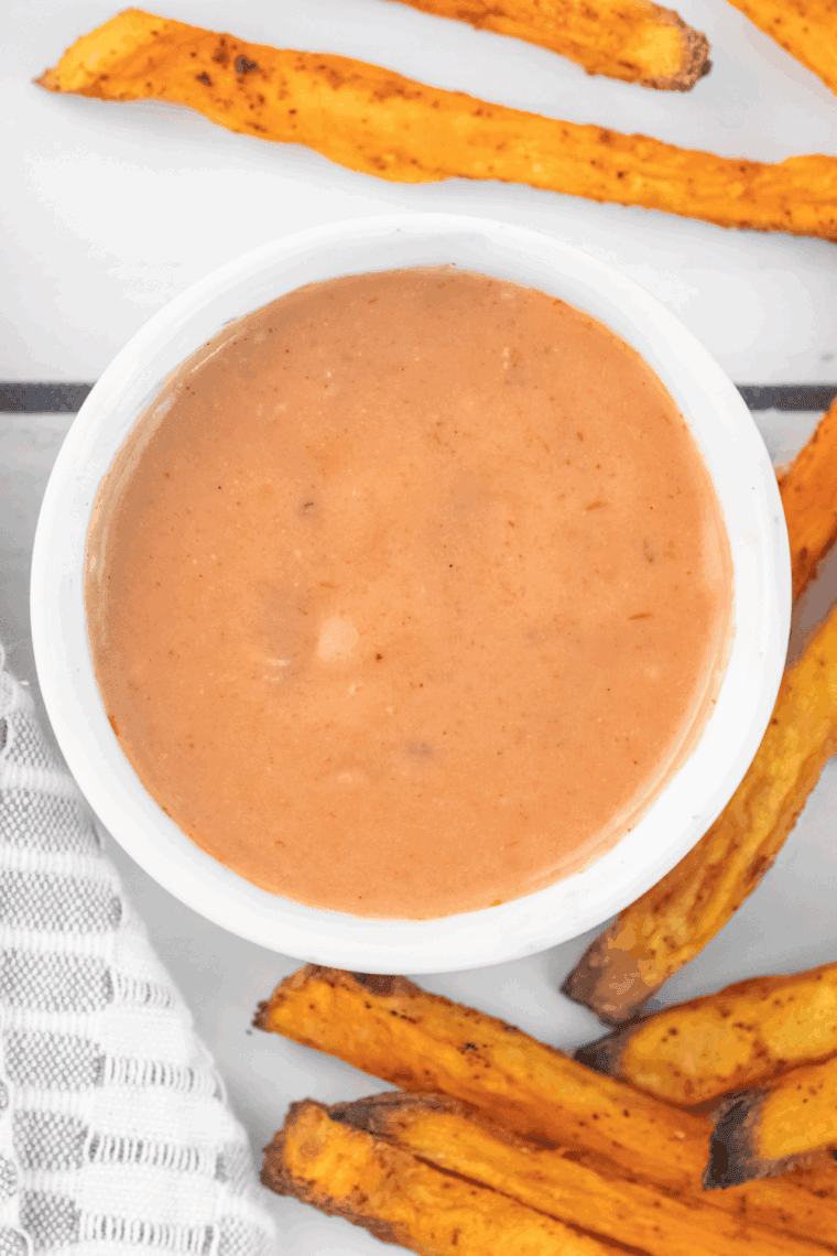 Bowl of creamy homemade Red Robin Campfire Sauce with fries on the side.