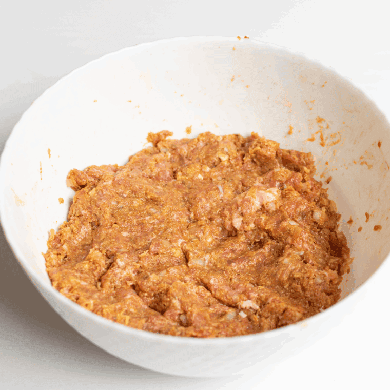 Mixing the meatloaf mixture, until well combined.