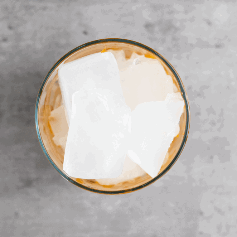 In a glass, pour 2–3 tablespoons of caramel syrup, adjusting the amount based on your desired sweetness level.