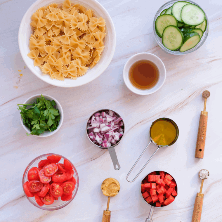 Ingredients needed for Fourth of July Pasta Salad on kitchen table.