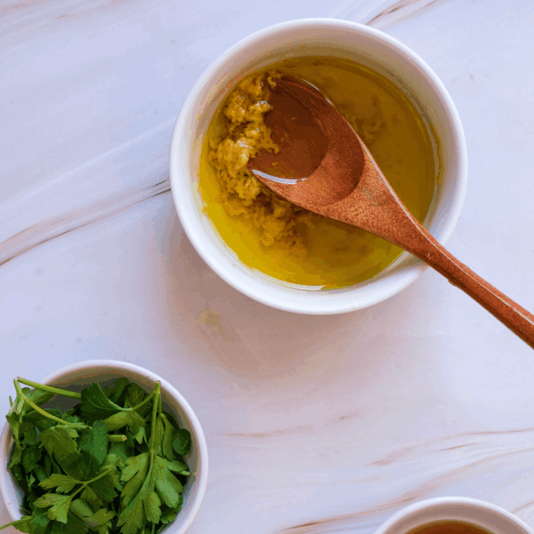Making the pasta salad dressing in a small bowl.