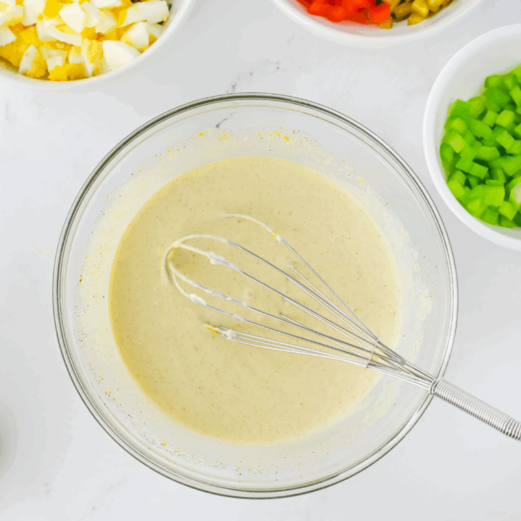 Combine all of the ingredients for the salad dressing in a large mixing bowl.