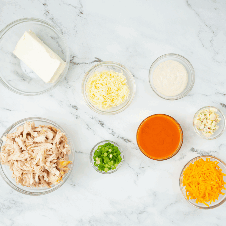 Ingredients needed for Hooters Buffalo Chicken Dip on kitchen table.