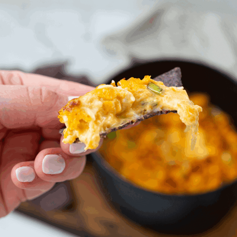 Creamy, cheesy Hooters Buffalo Chicken Dip served hot in a skillet, topped with melted cheese and green onions, surrounded by tortilla chips.