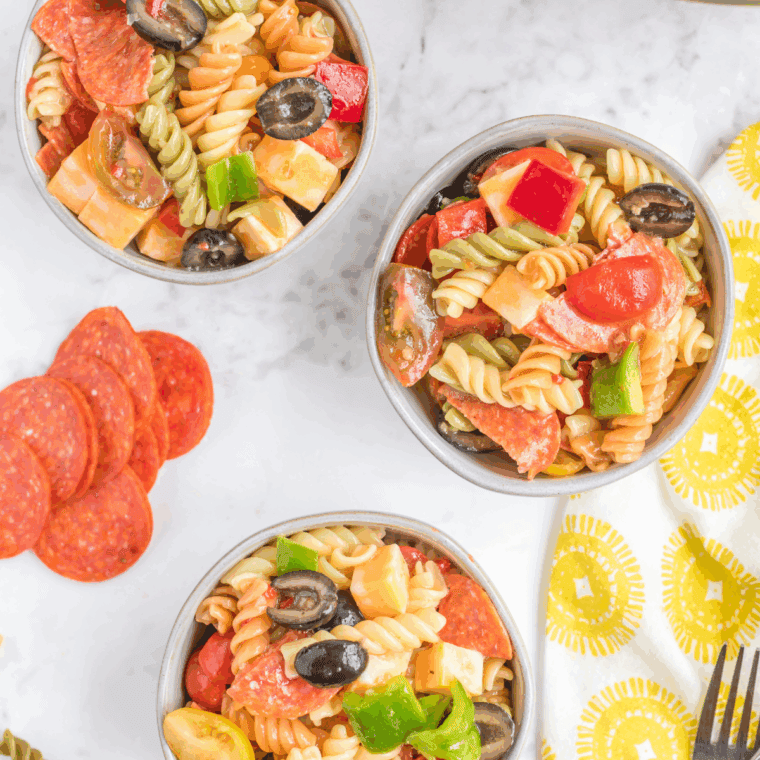 Bowl of creamy Hooters-style pasta salad with rotini, veggies, and dressing.