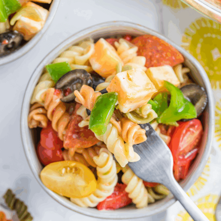 Creamy Hooters-style pasta salad with rotini pasta and diced vegetables in a white bowl.