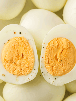 No-peel hard-boiled eggs cooked in the Instant Pot, sliced and ready for meal prep.