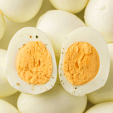 No-peel hard-boiled eggs cooked in the Instant Pot, sliced and ready for meal prep.