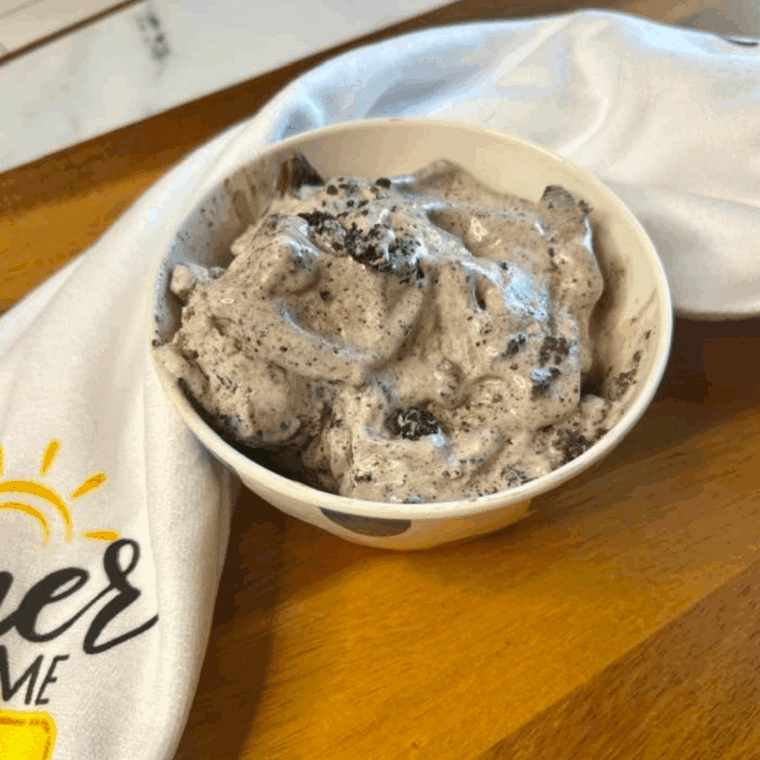 Homemade Ninja Creami Dirt Cake Ice Cream with chocolate base, cookie crumbles, and pudding swirls in a scoop.