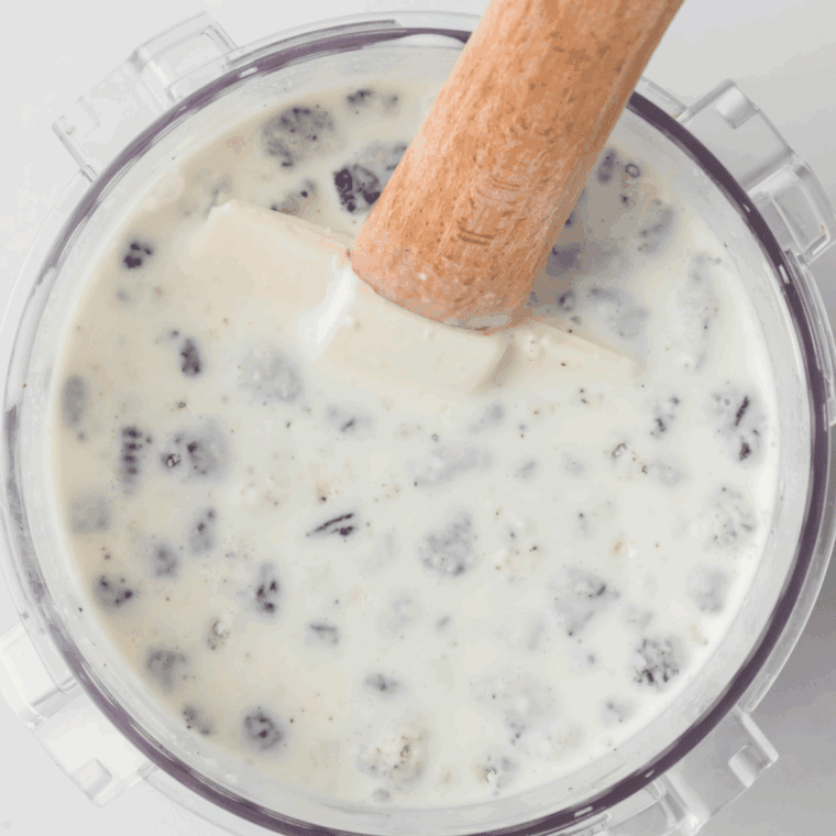 Mixing whole milk, heavy cream, and chocolate pudding mix in a bowl until smooth.