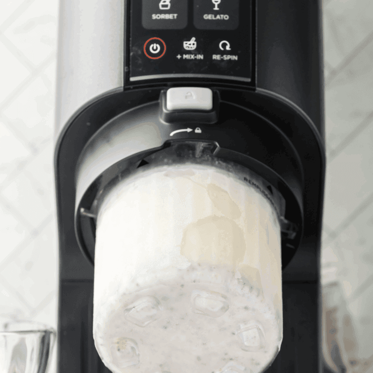 Placing frozen pint into Ninja Creami machine and selecting Ice Cream setting.