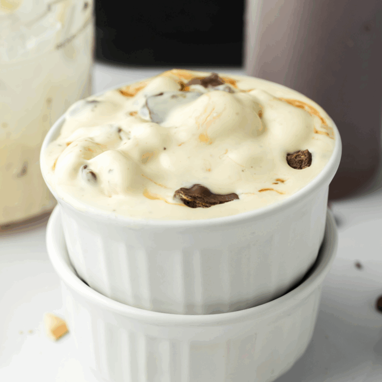 Homemade Americone Dream ice cream made in the Ninja Creami with fudge swirls and chocolate-dipped waffle cone pieces.