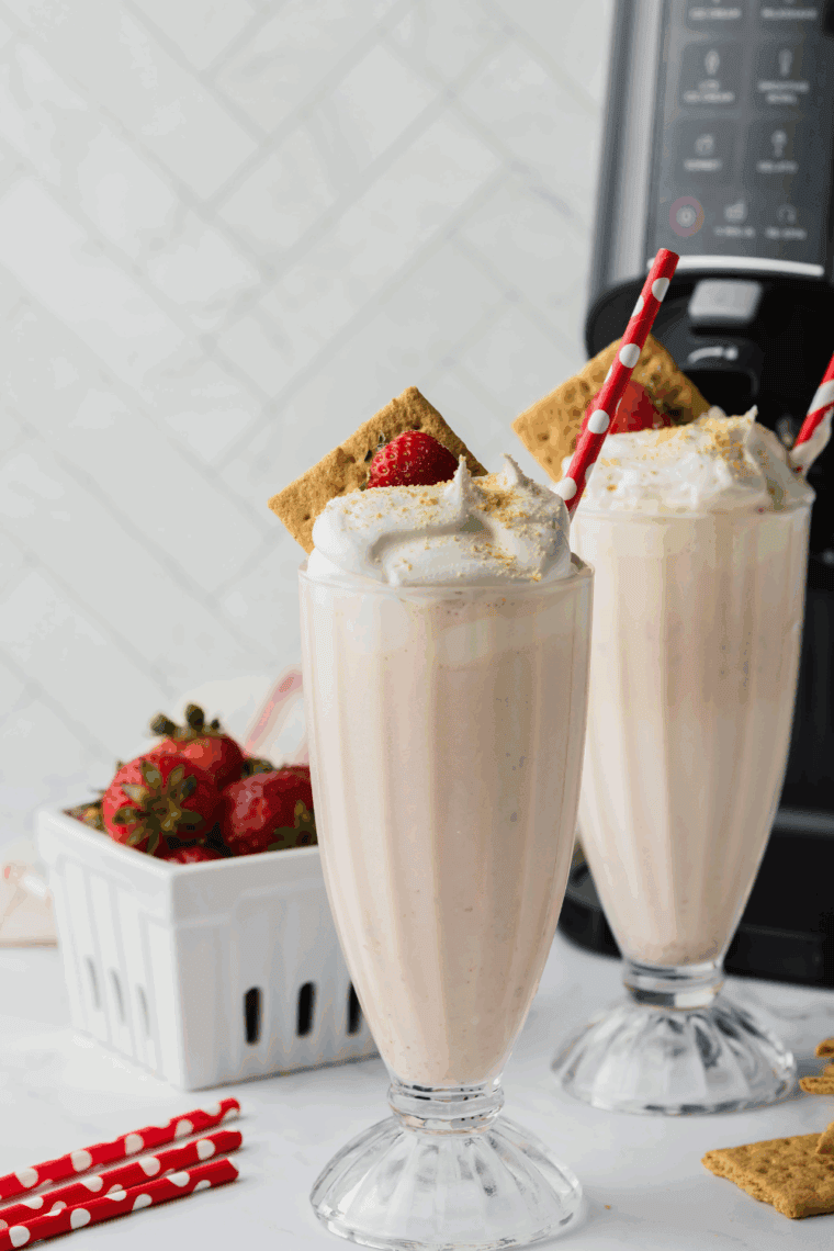 Ninja Creami Copycat Sonic Strawberry Cheesecake Milkshake with vanilla ice cream, cheesecake filling, strawberries, and graham crackers, blended to creamy perfection.