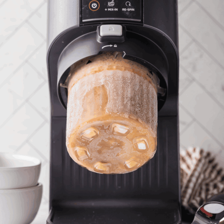Pouring the mocha frappuccino mixture into Ninja Creami pint container, spreading evenly, and freezing for 24 hours.