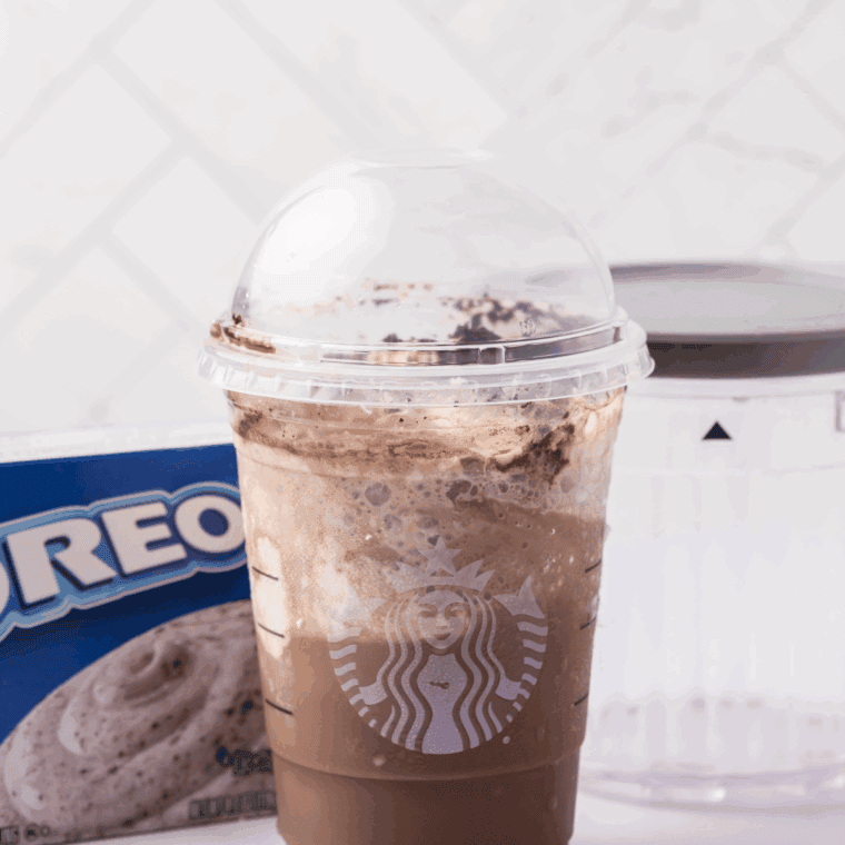 Rich and creamy Ninja Creami Copycat Starbucks Mocha Frappuccino, topped with whipped cream and chocolate drizzle, served in a glass.