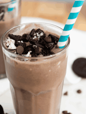 Glass filled with creamy Oreo shake topped with whipped cream and crushed Oreos, homemade Ninja Creami style.